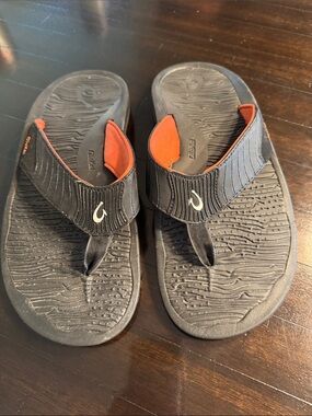 OluKai Men's Black Flip-Flops with Orange Accents